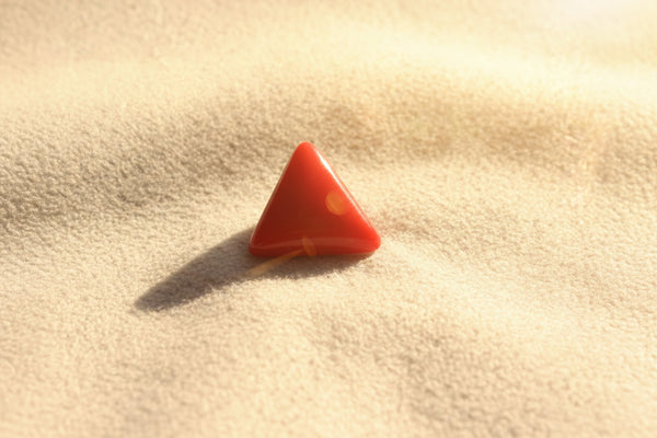 Red triangular stone on a gray background